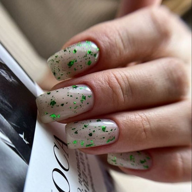 Milk manicure with green foil flakes