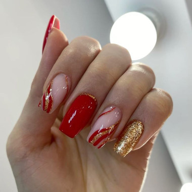 Red manicure with gold glitter