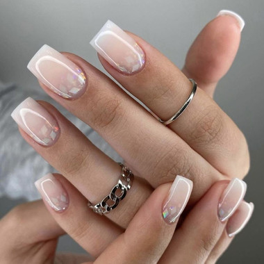 Contour French manicure with a milky base and glitter