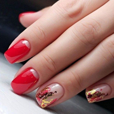 Red manicure with a transparent effect and gold decor