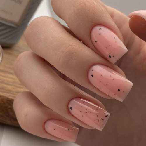 Delicate nude manicure with black speckles