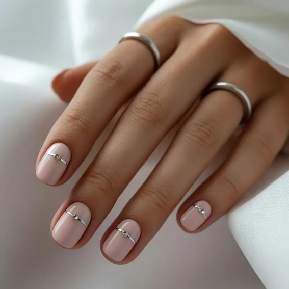 Nude manicure with horizontal silver tape