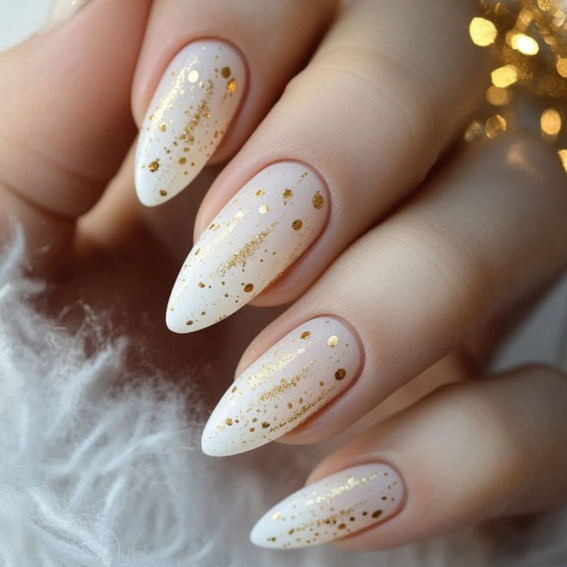 Milky manicure with gold shimmer